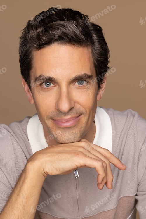 Preview: Studio Shot Of A Gorgeous Latino Man In His 40'S Smiling At The Camera On A Neutral Background.