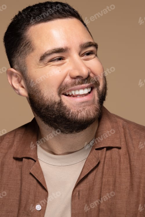 Preview: Close Up Portrait Of Attractive Hispanic Man In His 30S Smiling On Neutral Background