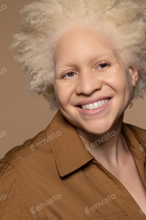 Preview: Portrait Of Beautiful Black Non-Binary Person With Albinism In Their 20S Posing On Neutral
