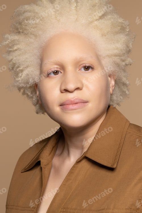 Preview: Portrait Of Beautiful Black Non-Binary Person With Albinism In Their 20S Posing On Neutral