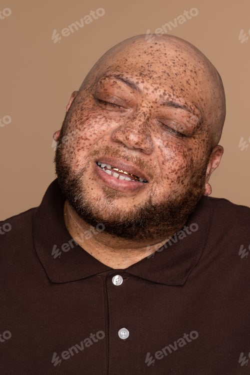 Preview: Profile Of An Attractive Multiracial Man In His 50'S With His Eyes Closed On A Neutral Background.