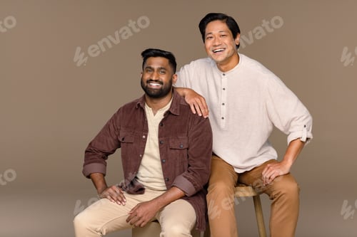 Preview: Studio Portrait Of Two Male Models In Their 20S And 30S Posed Smiling On A Neutral Background