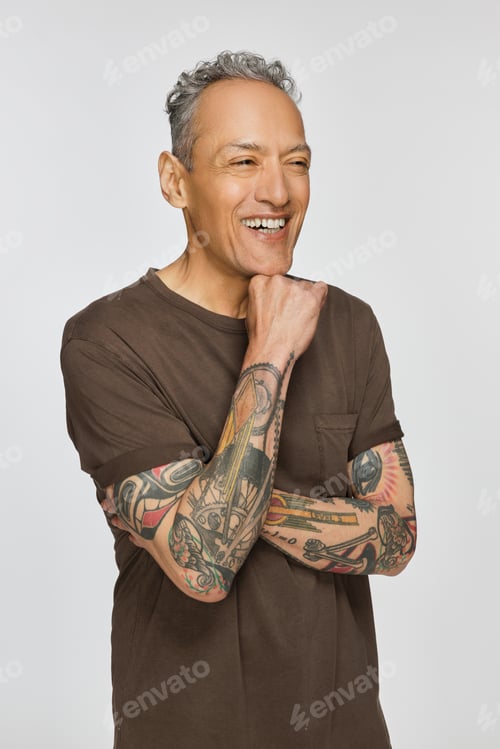 Preview: Studio Shot Of A Good Looking Multiracial Man In His 50'S Looking To The Side And Smiling On A