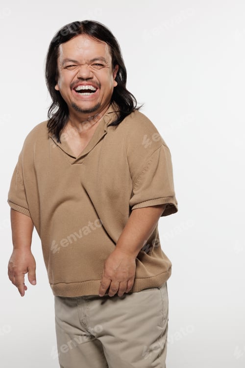Preview: Three Quarter Length Shot Of Hispanic Man In His 50S With Dwarfism Smiling And Posing On White