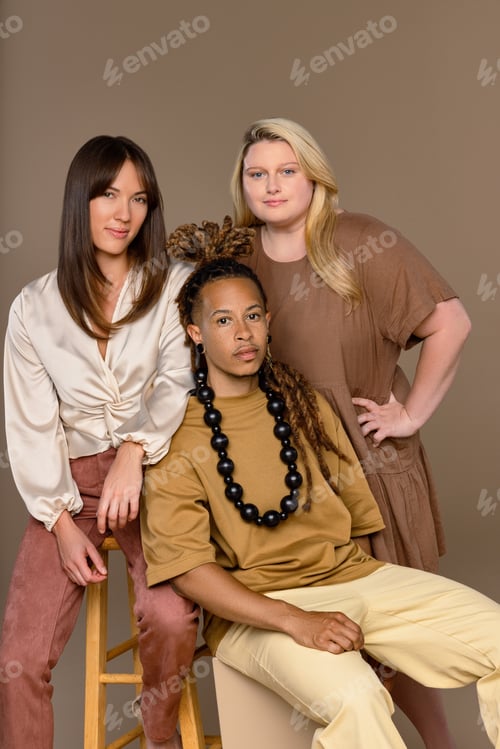 Preview: Studio Portrait Of A Non-Binary Black Creole In Their 30'S, A Caucasian Woman In Her 20'S, And A