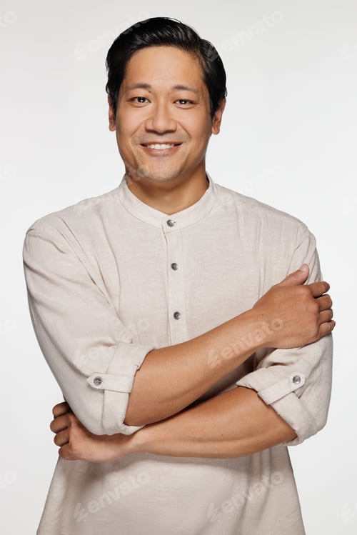 Preview: Three Quarter Length Shot Of Chinese Man In His 30S Smiling And Posing With Arms Crossed On White