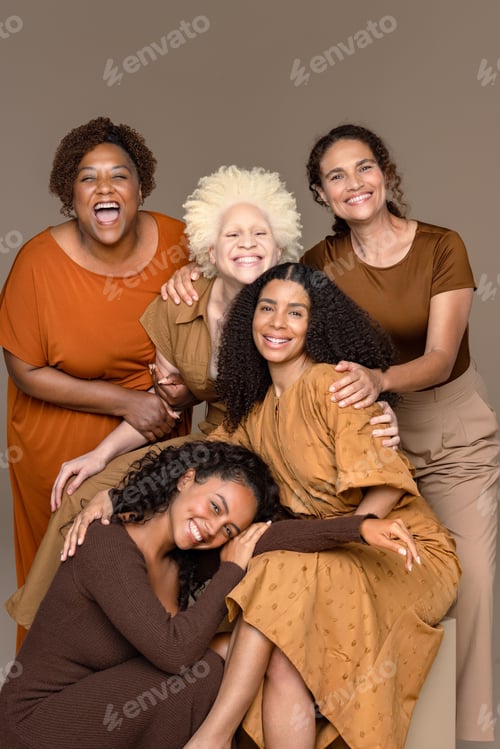 Preview: Three Quarter Length Shot Of A Group Of Beautiful Multiracial Women Laughing Together On A Neutral