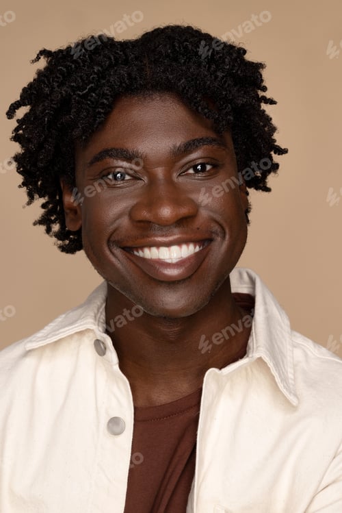 Preview: Studio Portrait Of An Attractive Liberian American Man In His 20'S Smiling On A Neutral Background.