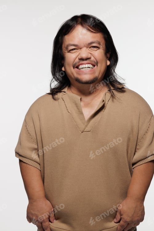 Preview: Three Quarter Length Shot Of Hispanic Man In His 50S With Dwarfism Smiling And Posing On White