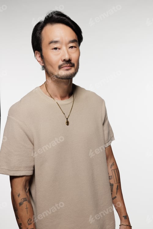 Preview: Three Quarter Length Shot Of Beautiful East Asian Man In His 40S Posing Confidently On White
