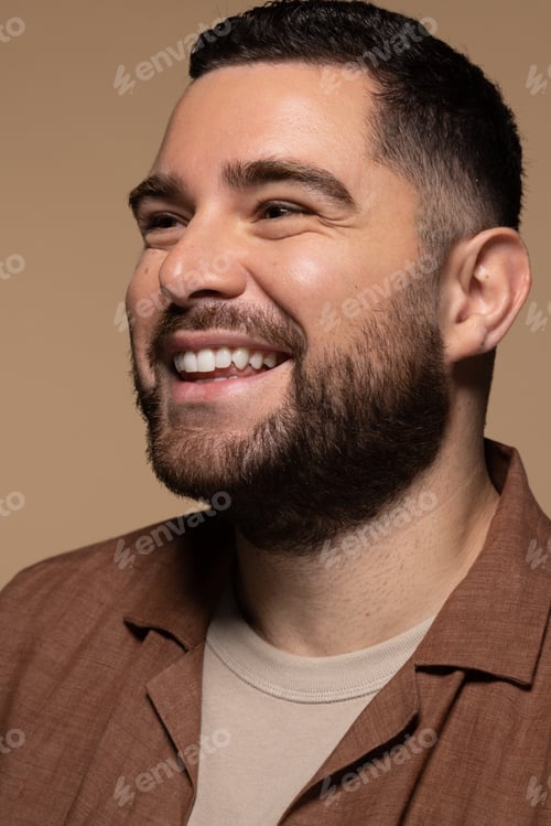 Preview: Close Up Portrait Of Attractive Hispanic Man In His 30S Smiling On Neutral Background