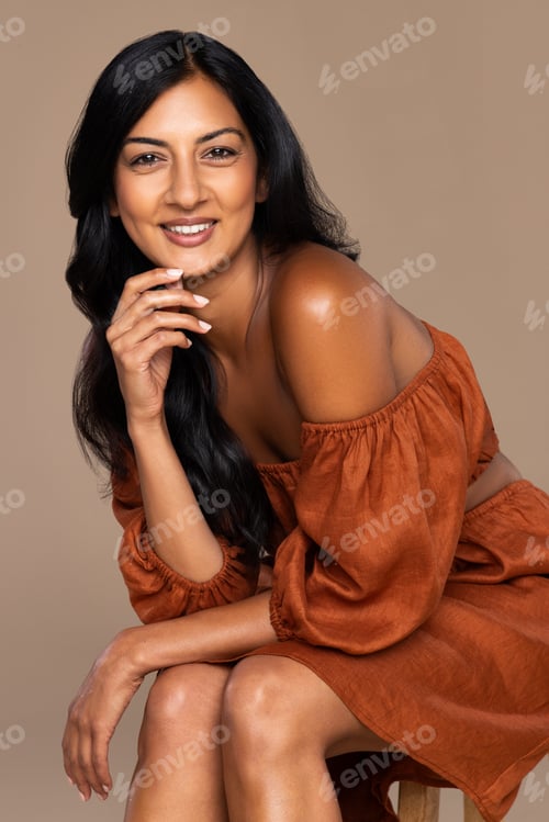 Preview: Studio Portrait Of An Attractive Indian Woman In Her 30'S Smiling Confidently On A Neutral