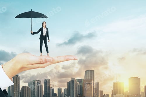 Preview: Big Hand Holding Young Woman With Umbrella On Bright City Background With Sunlight. Protection And