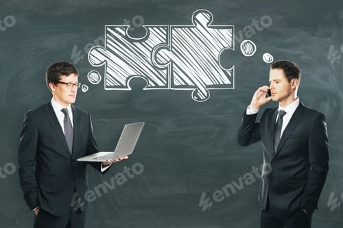 Preview: Businessmen With Puzzle Pieces On Chalkboard Wall Background. Teamwork And Colleagues Concept