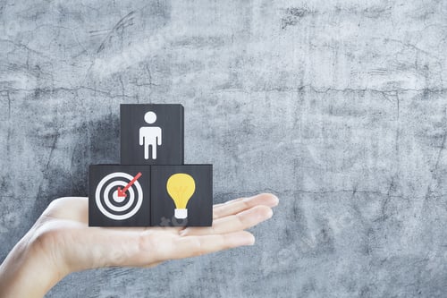 Preview: Hand Holding Business Sign On Black Cubes On Concrete Wall Background. Success And Startup Concept.