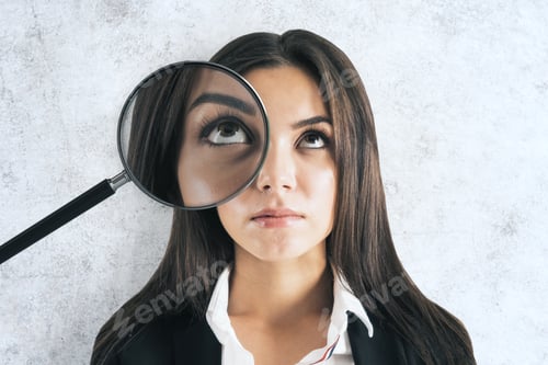 Preview: Portrait Of Attractive Young European Businesswoman With Magnifier On Eyes Standing On White