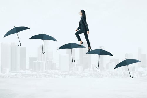 Preview: Side View Of Young Businesswoman Walking On Umbrella Ladder On City Background. Financial Security