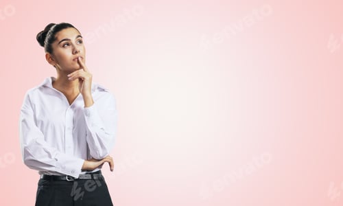 Preview: Thinking Concept With Pensive Girl In White Shirt And Dark Trousers Standing On Abstract Light Pink