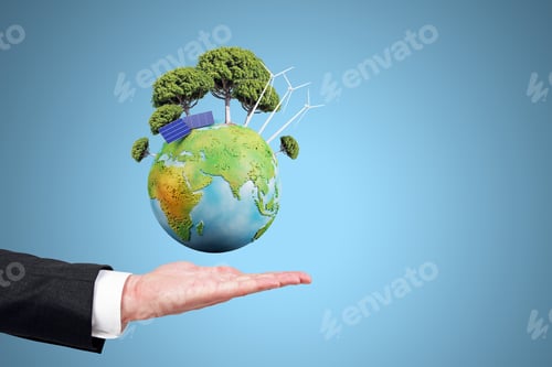 Preview: Close Up Of Businessman Hand Holding Creative Globe With Trees And Solar Panels On Blue Background