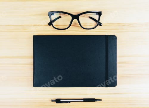 Preview: Blank Diary Cover With Eyeglasses And Pen On Wooden Table