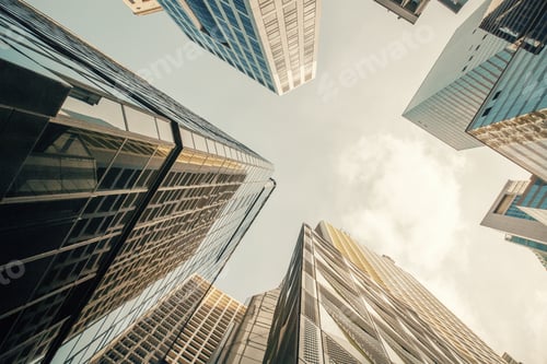 Preview: Bottom View Of Skyscrapers On Bright Blue Sky Background. Urban And Business Concept