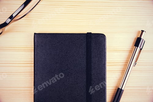 Preview: Top View On Blank Black Diary With Pen And Eyeglasses, Mock Up