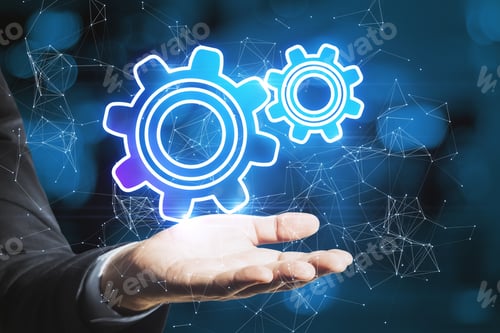 Preview: Close Up Of Businessman Hand Holding Abstract Glowing Gear Wheels On Blue Bokeh Background With