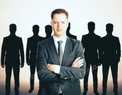 Preview: Leadership Concept With Handsome Caucasian Businessman In Front Of Businesspeople Silhouettes