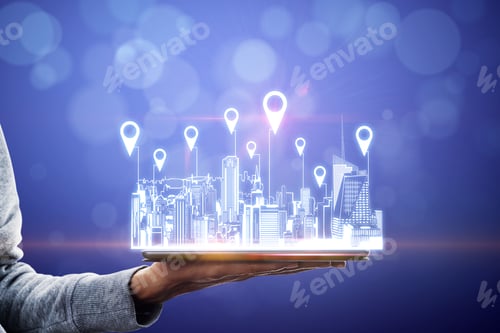 Preview: Close Up Of Hand Holding Tablet With City Hologram And Location Pins On Blurry Background With
