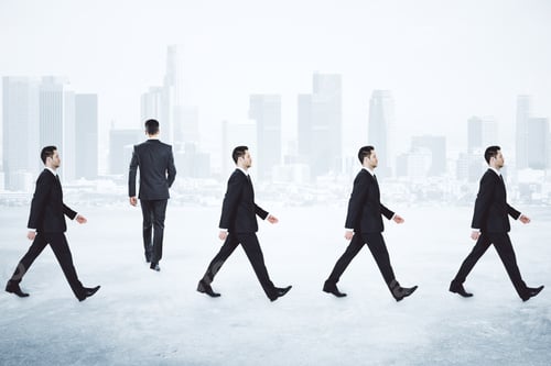 Preview: Businessmen Walking in Suits with City Skyline