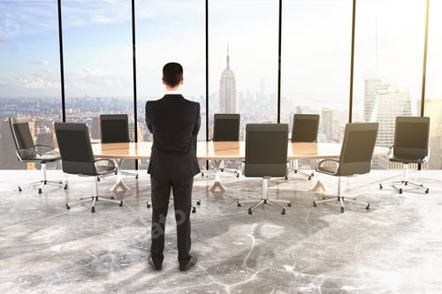 Preview: Businessman In Conference Room With Big Round Table And Chairs In The Room With Concrete Floor And