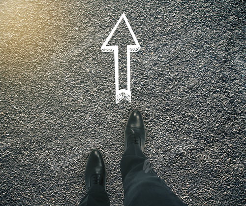 Preview: Guidance Concept With Businessman Feet And Arrow Sketch Showing Direction On Asphalt