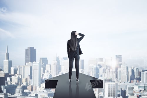 Preview: Back View Of Young Businesswoman Standing On Arrow On New York City Background. Growth And Up
