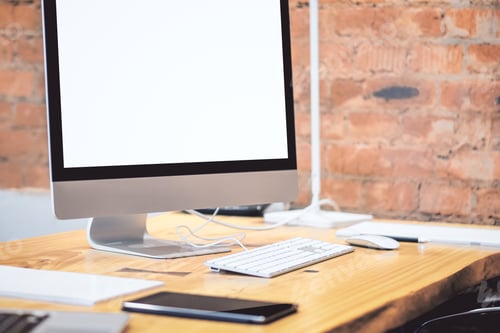 Preview: Creative Designer Desktop With Empty White Computer Screen And Other Objects On Blurry Red Brick