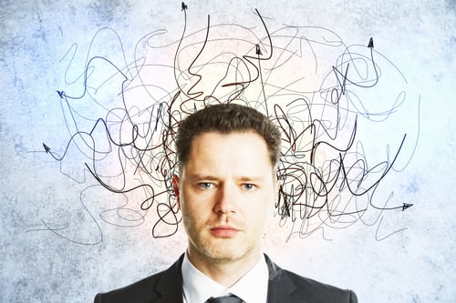 Preview: Businessman With Drawn Arrows Over Her Head On Concrete Wall. Leadership And Way Concept. Close Up