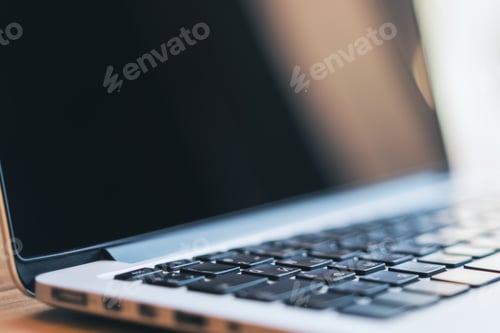 Preview: Side View Of Creative Empty Laptop Computer Screen On Wooden Desktop. Blurry Background