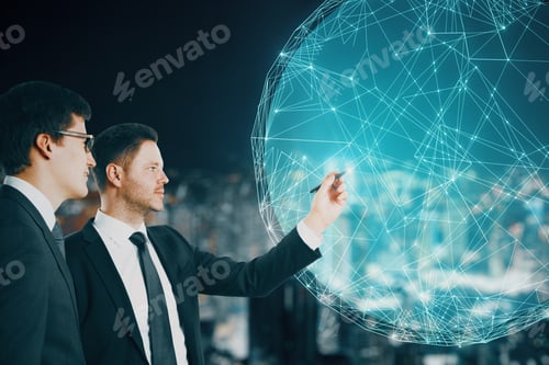 Preview: Young European Businessmen Pointing At Creative Glowing Polygonal Globe Hologram On Blurry Night