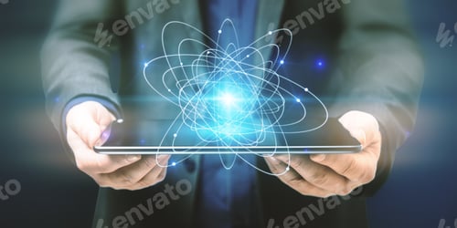 Preview: Close Up Of Businessman Hands Holding Tablet With Abstract Glowing Atom Hologram On Dark