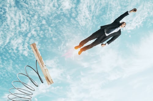 Preview: Businessman Lauching Off Big Spring On Sky Background With Clouds. Startup And Success Concept
