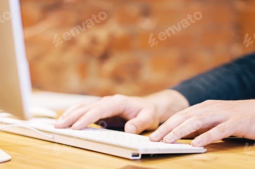 Preview: Side View Of Businessman Hands Typing On White Computer Keyboard. Blurry Background. Technology And