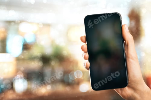 Preview: Hand Holding Empty Smartphone On Blurry Background. Mock Up