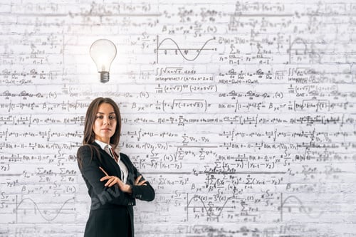 Preview: Portrait Of Focused Young European Businesswoman With Folded Arms And Glowing Lamp Standing On