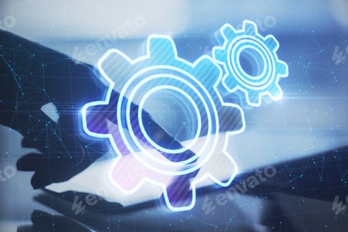 Preview: Close Up Of Backlit Hand Pointing At Tablet At Desktop With Abstract Glowing Gear Wheels On Blurry