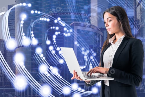 Preview: Attractive Young European Businessman Using Laptop With Creative Circular Light On Blurry City