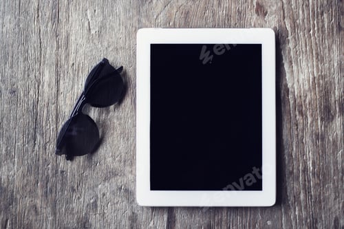 Preview: Digital Tablet With Sunglasses On A Wooden Table