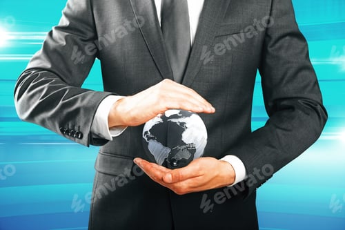 Preview: Closeup Of Businessman Hands Holding Small Terrestrial Globe On Blue Background. Eco Friendly