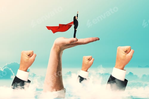 Preview: Businesswoman With Red Cape Standing On Abstract Hands And Looking Into The Distance. Blue Sky