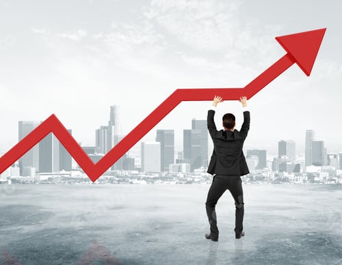 Preview: Businessman Holding Red Arrow From Business Graph At City Background