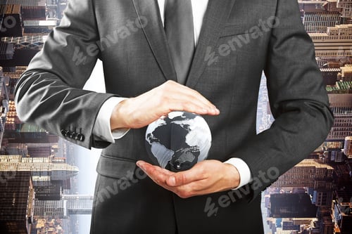 Preview: Closeup Of Businessman Hands Holding Small Terrestrial Globe On City Background. Eco Friendly