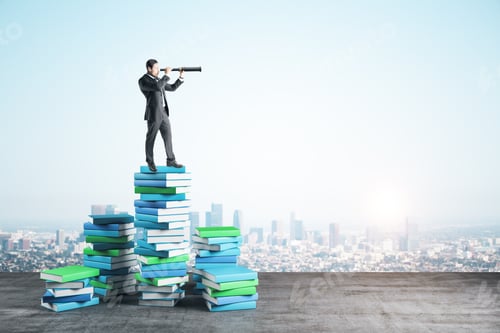 Preview: Businessman With Telescope On Color Books On City Background. Growth, Knowledge And Vision Concept